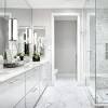 Accessories and furniture in modern bathroom designs frequently follow the style's general aesthetic. 1