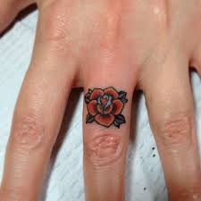 Rose tattoo design on middle finger. 45 Flower Tattoos On Fingers