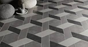 The base flooring is of plain marble with a unique design in the middle that is in contrast to the background, making it look attractive. Coverings 2016 Preview Tile Of Spain Tile Design Tile Inspiration Caning