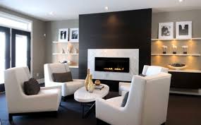 A round rain shower head is fixed to white and gray marble shower ceiling over black floor tiles ending at a marble bench fixed against a marble surround. Hot Fireplace Tile Trends Bedrosians Tile Stone