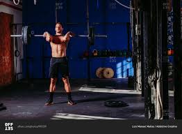 Athletic male with naked torso doing deadlift with heavy barbell while  pumping muscles in sports center stock photo - OFFSET