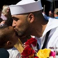Ensign Jordan Packer greets his family after returning to Naval Station  Norfolk (NSN) with the aircraft carrier USS George H. W. Bush (CVN 77).