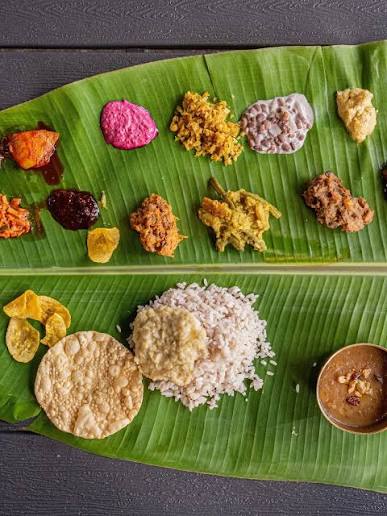 An Onam Sadya is Kerala's grand vegetarian feast at the harvest festival of  Onam, with over 20 dishes served on a banana leaf. Sadya has always meant  more to me than just
