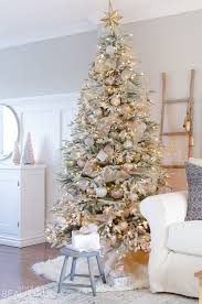 A Snowy Flocked Christmas Tree Christmas Tree Decorating Ideas In 2020 Cool Christmas Trees Snowy Christmas Tree Flocked Christmas Trees Decorated