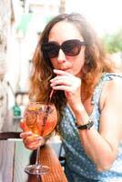 Smiling young girl drinks a cool cocktail and relaxes in a summer street  cafe. Summer. Vacation. Selective focus. 51021418 Stock Photo at Vecteezy