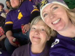 What shirt is mom wearing at the Vikings game?