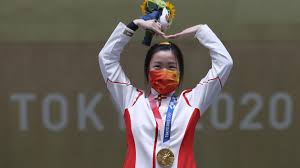 China's qian yang celebrates with her gold medal after winning the 10m air rifle women's final at the asaka shooting range on the first day of the tokyo 2020 olympic games in japan. T7dkygxxxd6smm