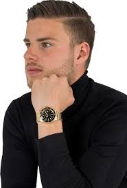 Stylish Guess U11622L3 watch for women with a white polycarbonate strap and  case. White dial with silver-tone hands and markers, day and date sub-dial,  quartz movement, and mineral glass. Water resistance is