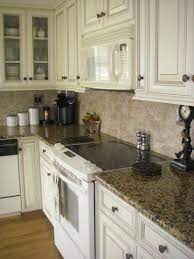 The white distressed kitchen cabinets are easy to clean and maintain their lustrous looks so that the kitchen sustains a welcoming and homely feel. Giallo Fiorito Granite Kitchen Design Decor Home Depot Countertops Kitchen Redo
