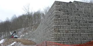 Slopes can create many challenges when designing a functional garden and usable outdoor space. Pinnacle Design Build Group Inc Large Block Retaining Walls