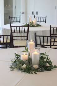 greenery with glass cylinder vade and pillar candles white flower wedding center peace all decoration table mariage idee deco table mariage deco table mariage