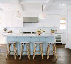 Metal pulls on the cabinets and drawers add shine to the room. Inspiring White Kitchen With Light Blue Island Home Bunch Interior Design Ideas