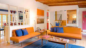 A table and a rocking chair in a retro casual look, wood floors, desk and shelves are decorated in white and refreshing. 23 Fruity Orange Sofa Living Room Home Design Lover