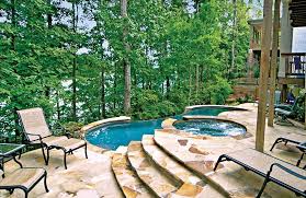 Vanishing Edge Pool With Spa In The Woods Blue Haven Pools Infinity Pool Backyard Sloped Backyard