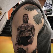 What does mike tyson's tribal face tattoo mean? Mike Tyson Tattoo On The Right Upper Arm