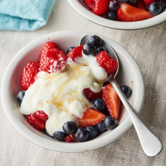 Greek yogurt topped with berries, AI generated