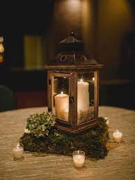 15 Beautiful Lantern Centerpieces For Any Wedding Style Lantern Centerpiece Wedding Wooden Lanterns Centerpieces Rustic Wedding Centerpieces