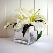 Our skilled florists may substitute flowers for one similar in style, quality and value. Lilies In Mirror Cube Vase Bliss And Bloom