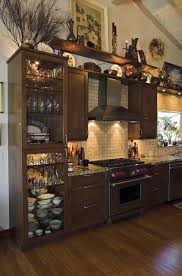 The space above kitchen cabinets is an ideal area to further decorate to give your kitchen greater design depth. How To Decorate The Top Of A Cabinet And How Not To Designed