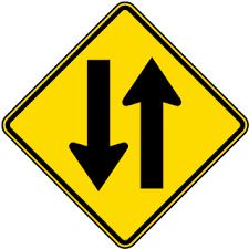 Black And Yellow Sign With Arrow Meaning Two Way Street Sign Traffic Signs Traffic Symbols Signs