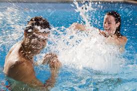 At or near the side of a pool. Healthy Lifestyle Couple Having Fun At The Swimming Pool Stock Photo Picture And Royalty Free Image Image 1290443