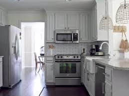 This Late 1980s Kitchen Is Updated By Painting The Oak Cabinets A Soft Warm Gray Refinishing The Cottage Style Kitchen White Cottage Kitchens Cottage Kitchens