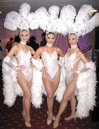 A showgirl is a female dancer or performer in a stage entertainment show intended to showcase the performer's physical attributes, typically by way of revealing clothing, toplessness, or nudity. Pin On Wedding Vegas