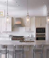 The pendant lamp features the directional light and is made of solid wood. Black Pendants In A White Kitchen