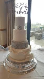 White And Silver 4 Tier Wedding Cake With Diamante And Swag Details Pearl Brooch And Silver Confetti Cakesbysoph 4 Tier Wedding Cake Tiered Wedding Cake Cake