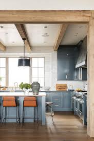 orange stools at blue kitchen island