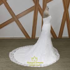 A long boho lace dress with a v cut back, long bell lace trim sleeves and a train. Strapless Beaded Applique Sheath Wedding Dress With Lace Up Back Vampal Dresses