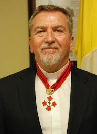 Father Richard Invested Into Order of Fleur de Lis