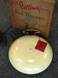 mild steel disk shaped belling bed warmer containing electrical components c1950 vintage bed water lighting warmers