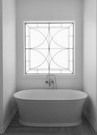 The bathroom environment is vulnerable to mold spores formation, therefore, the a wavy wall design is copied in the framing of this seaside window. Sneak Peeks A Big Remodel Almost Complete Designed Leaded Glass Door Glass Doors Interior Stained Glass Door