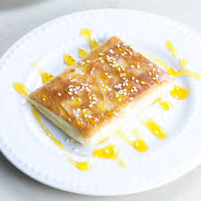 Phyllo Wrapped Feta Cheese With Honey And Sesame Seeds Lemon Olives Exploring Greek Food And Culture The Mediterranean Lifestyle And Traveling Greece Recipe Greek Recipes Food Greek Appetizers