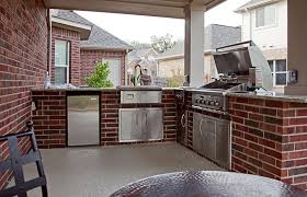 Builders say brick or concrete blocks create structurally sound outdoor kitchens when built on a level surface. Brick Outdoor Kitchen With Granite Countertops Built In Grill Sink And Refrigerator Spindler Construction Austin Texas