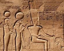 Image of relief depicting the Theban Triad: AmunRe, Mut, and Khonsu, showcasing their relationship and importance in Egyptian religion.