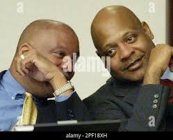 Rep. Bruce Antone, D-Orlando, left, and Rep. Terry Fields, D-Jacksonville,  right, talk during the House session, Tuesday, March 30, 2004, in  Tallahassee, Fla.(AP Photo/Phil Coale Stock Photo