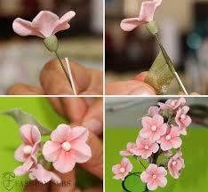 These simple white with green flowers are great to use as a filler with bigger sprays. Gumpaste Cherry Blossom Flowers Tutorial Fondant Flower Tutorial Gum Paste Flowers Tutorials Sugar Flowers Tutorial