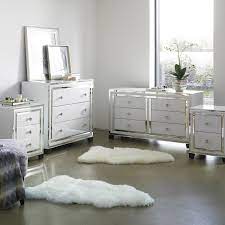 Cozy blue and white powder room features an aqua blue washstand adorning brass pulls and topped with a white quartz. Dash White Mirrored Bedroom Collection