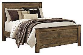 Replicated oak grain with authentic touch. Trinell Queen Panel Bed Ashley Furniture Homestore