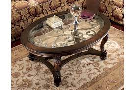 Swirls of metal accents add a lovely dimension under a beveled glass inset tabletop. Norcastle Coffee Table Ashley Furniture Homestore