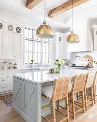 In the kitchen below, the movement of the granite's natural stone pattern, the geometry of the backsplash tile, and the sparkle of the mosaic tile statement wall contribute to the cozy vibe. 11 White Kitchen Design Ideas To Add Cozy Factor Hello Lovely