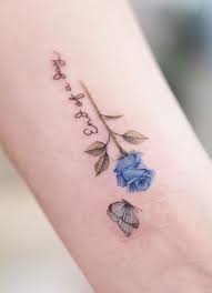 A large dark blue butterfly tattoo on the back. Blue Rose Tattoos Meanings Tattoo Designs Placement