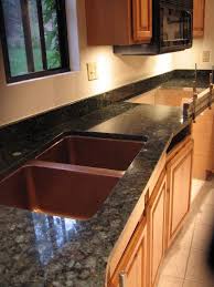 Using the island as both a work area and a serving area makes for easy cleanup and optimizes the social atmosphere. Dusty Coyote Mountain House Kitchen Remodel Uder Way Kitchen Remodel Kitchen Countertops Kitchen Countertops Granite Colors