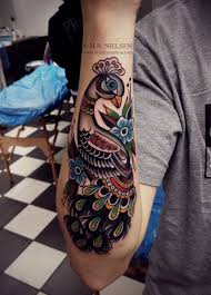 Old School Style Peacock Watercolor Tattoo On Forearm Bird Flowers Leaves Peacock Tattoo Tattoos Forearm Tattoos