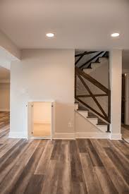 Cable Railing With Wood And Hidden Kid Playroom Farmhouse Basement Kansas City By Apple Tre Basement Flooring Options Basement Flooring Basement Decor