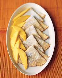 Coconut Crepes With Fresh Mangoes Recipe Martha Stewart Living Freshly Grated Coconut And Unsweetened Coconut Milk Mango Recipes Coconut Recipes Sweet Meat