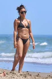 Eva Longoria looks incredible in a black string bikini as she hits the beach  in Spain