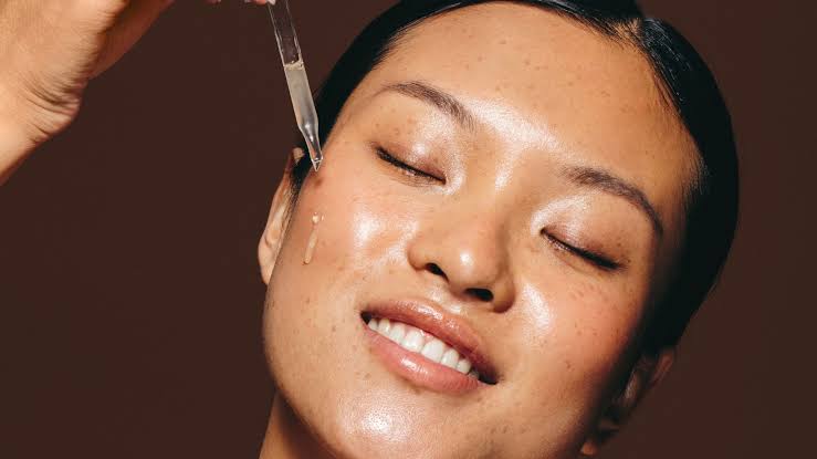 Targeted application of concentrated anti-ageing facial serum, AI generated